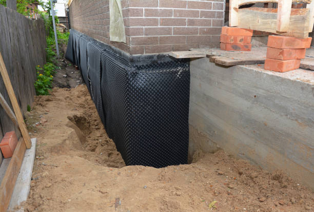 Happy homeowners after waterproofing job in Adrian